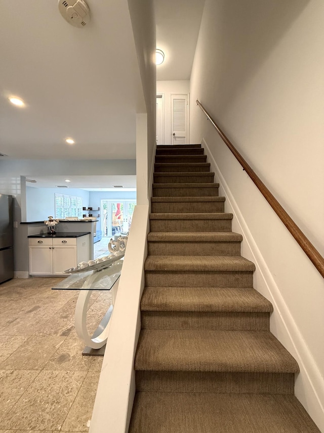 staircase with recessed lighting
