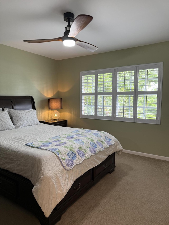 bedroom with baseboards, carpet, and a ceiling fan