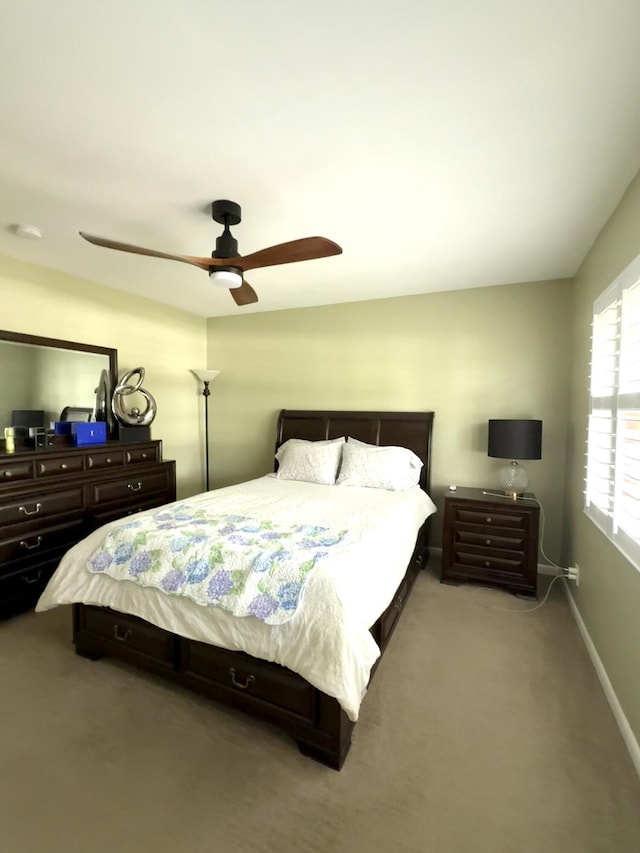 bedroom with carpet floors, ceiling fan, and baseboards
