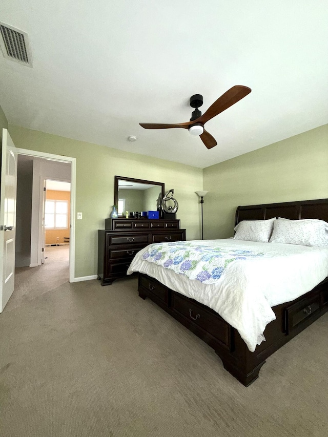 carpeted bedroom featuring baseboards and a ceiling fan