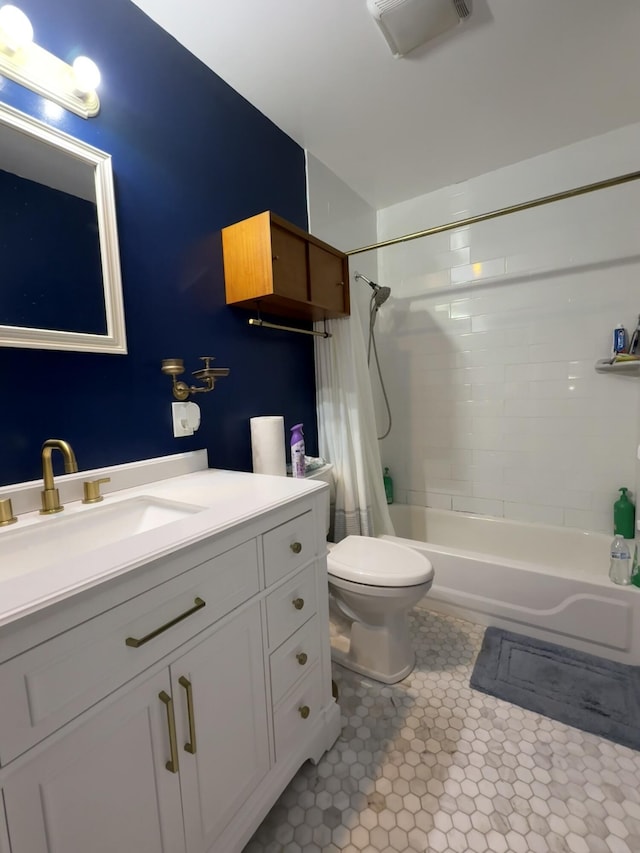 bathroom featuring toilet, shower / tub combo, vanity, and tile patterned floors