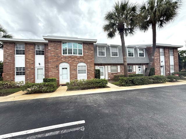 townhome / multi-family property featuring brick siding