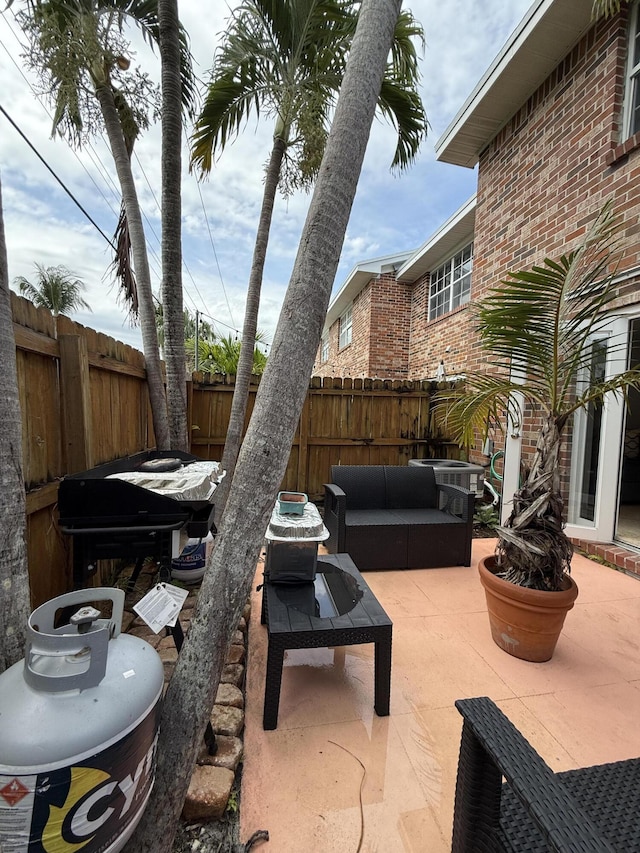 view of patio with a fenced backyard and an outdoor hangout area