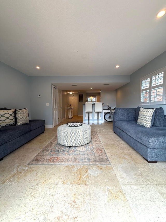 living room featuring recessed lighting and baseboards