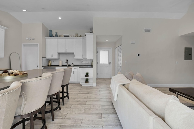 9794 Ridgecreek Rd, Boca Raton, FL 33496 - living area featuring electric panel, recessed lighting, and vaulted ceiling