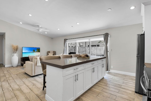 9794 Ridgecreek Rd, Boca Raton, FL 33496 - kitchen featuring dark countertops, white cabinets, light wood-style floors, a ceiling fan, and recessed lighting
