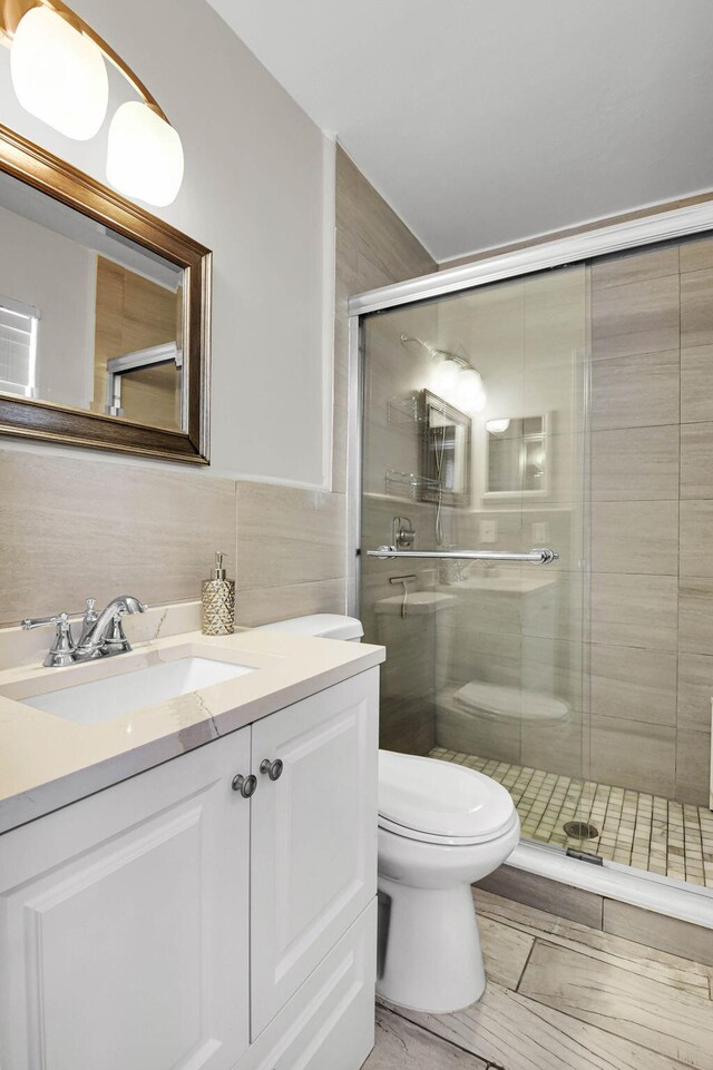 9794 Ridgecreek Rd, Boca Raton, FL 33496 - bathroom with toilet, a shower stall, vanity, and tile walls