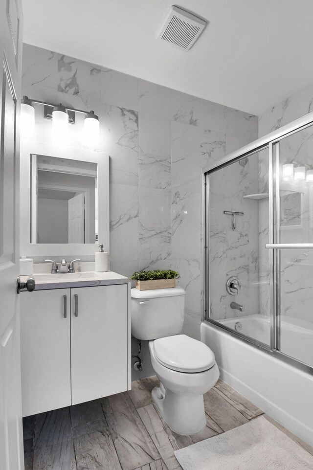 9794 Ridgecreek Rd, Boca Raton, FL 33496 - bathroom with toilet, combined bath / shower with glass door, vanity, and marble finish flooring