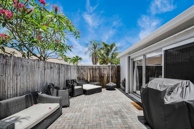 9794 Ridgecreek Rd, Boca Raton, FL 33496 - view of patio featuring a grill, a fenced backyard, and an outdoor hangout area