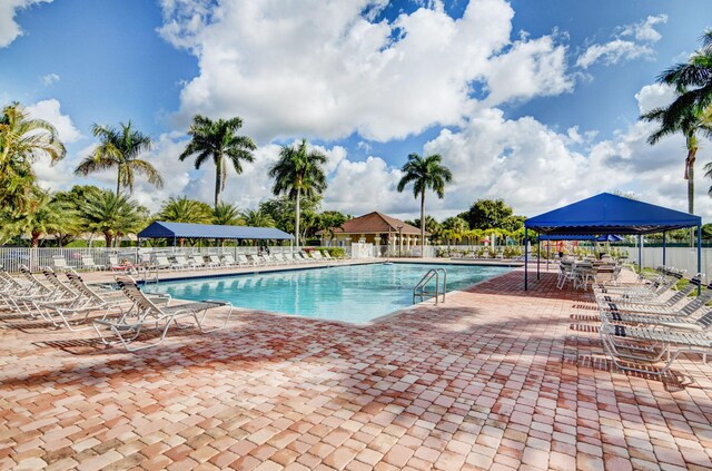 9794 Ridgecreek Rd, Boca Raton, FL 33496 - community pool with a gazebo, fence, and a patio area