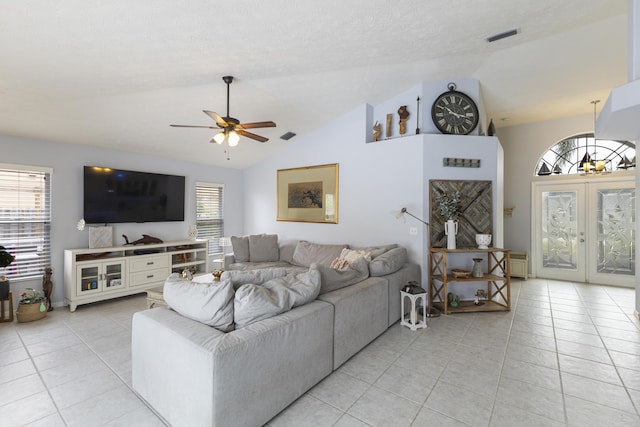 living room with light tile patterned flooring, ceiling fan, lofted ceiling, and french doors