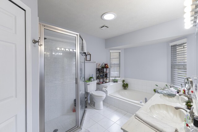 full bath featuring tile patterned flooring, a garden tub, a shower stall, toilet, and double vanity