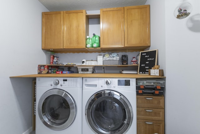 washroom featuring washing machine and dryer and cabinet space