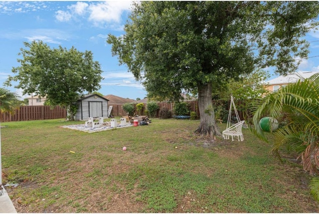 view of yard featuring a storage unit, an outbuilding, and a patio