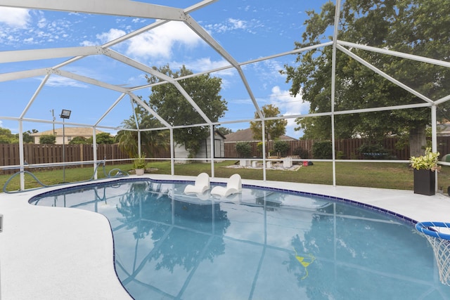 view of pool featuring a patio area, a storage shed, an outdoor structure, and glass enclosure