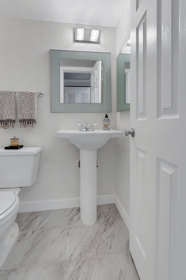 4030 Durham B, Deerfield Beach, FL 33442 - half bathroom featuring toilet, marble finish floors, and baseboards