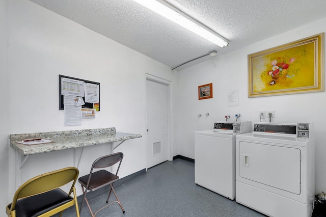 4030 Durham B, Deerfield Beach, FL 33442 - shared laundry room featuring independent washer and dryer, a textured ceiling, and baseboards