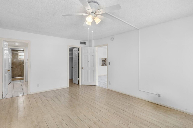 2871 N Ocean Blvd Unit M334, Boca Raton, FL 33431 - spare room featuring ceiling fan, wood finished floors, a textured ceiling, and baseboards