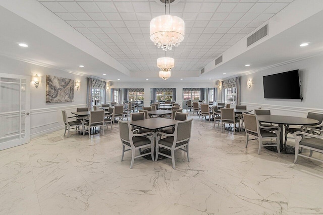 2871 N Ocean Blvd Unit M334, Boca Raton, FL 33431 - dining room with a chandelier, a raised ceiling, recessed lighting, crown molding, and wainscoting