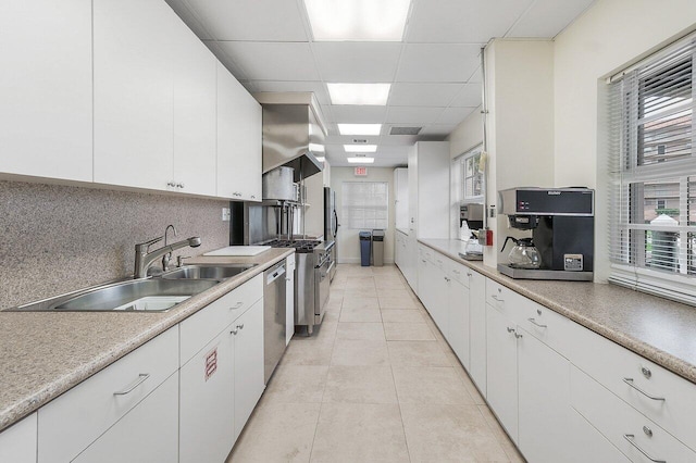 2871 N Ocean Blvd Unit M334, Boca Raton, FL 33431 - kitchen with a sink, backsplash, appliances with stainless steel finishes, white cabinets, and a paneled ceiling