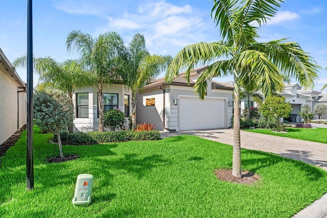 9333 Mountain Pine Grv, Boynton Beach, FL 33473 - obstructed view of property featuring driveway, an attached garage, stucco siding, and a front yard