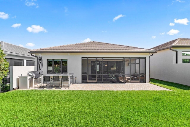 9333 Mountain Pine Grv, Boynton Beach, FL 33473 - rear view of house featuring a tile roof, a lawn, stucco siding, a patio area, and a sunroom
