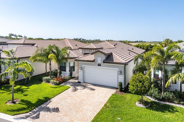 9333 Mountain Pine Grv, Boynton Beach, FL 33473 - view of front of home featuring a garage, decorative driveway, stucco siding, a tile roof, and a front lawn