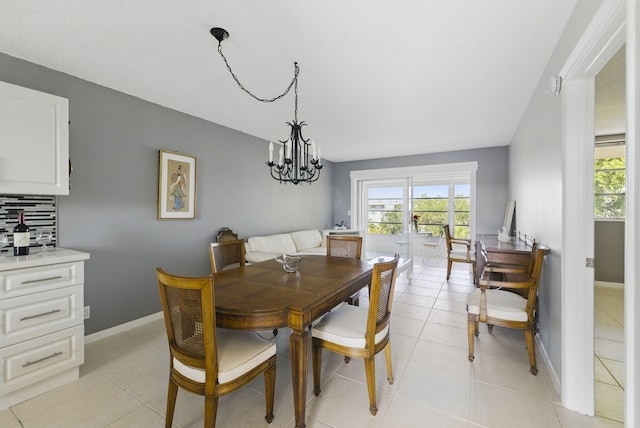 dining area with plenty of natural light, a chandelier, and light tile patterned floors