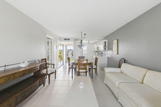 living room featuring a chandelier and light tile patterned flooring
