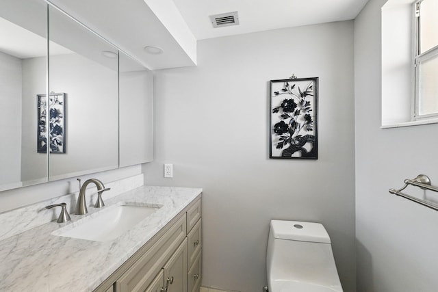 bathroom featuring vanity and toilet