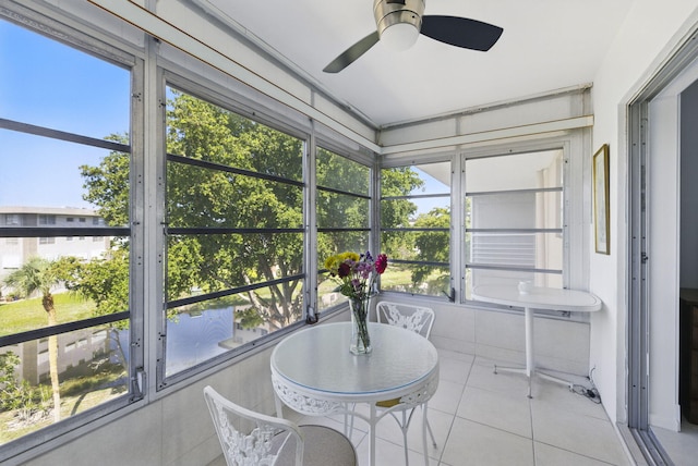 sunroom featuring ceiling fan, plenty of natural light, and outdoor dining space