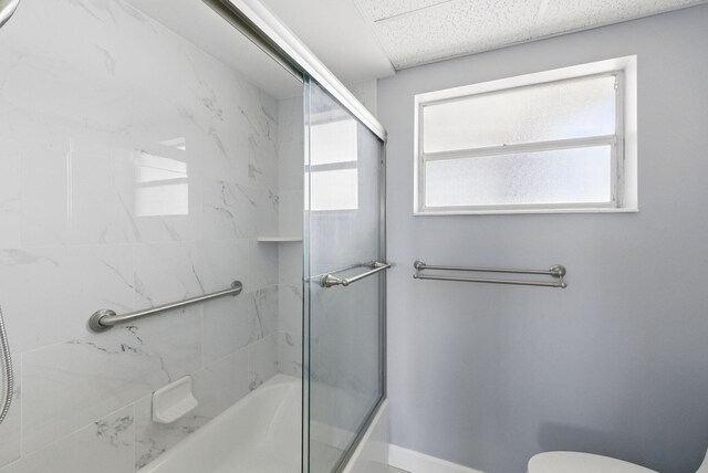 full bathroom featuring toilet and enclosed tub / shower combo