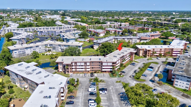 drone / aerial view of apartment complex / building and a nearby body of water