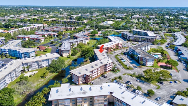 bird's eye view of apartment complex and a large body of water