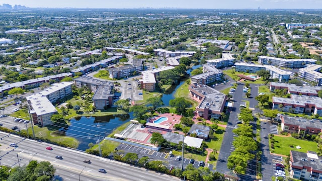 aerial view of property's location featuring a nearby body of water and nearby urban area