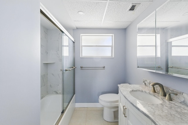 bathroom featuring toilet, vanity, baseboards, enclosed tub / shower combo, and a paneled ceiling