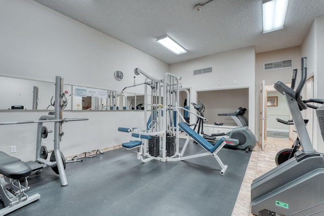 exercise room with a textured ceiling