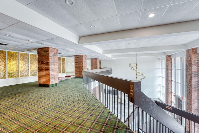 hallway with an upstairs landing, carpet flooring, and recessed lighting