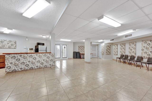 miscellaneous room featuring light tile patterned floors and baseboards