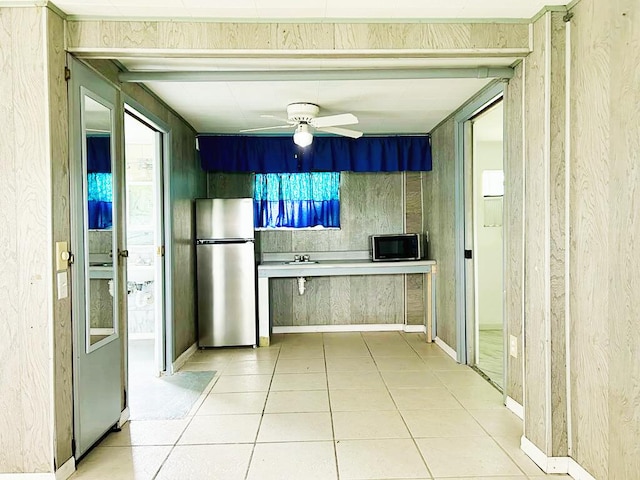 851 Riverside Dr, Moore Haven, FL 33471 - kitchen featuring freestanding refrigerator, black microwave, ceiling fan, light tile patterned floors, and a sink