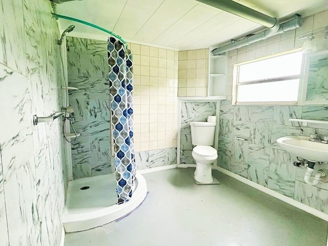 851 Riverside Dr, Moore Haven, FL 33471 - bathroom featuring a stall shower, toilet, a sink, tile walls, and concrete floors