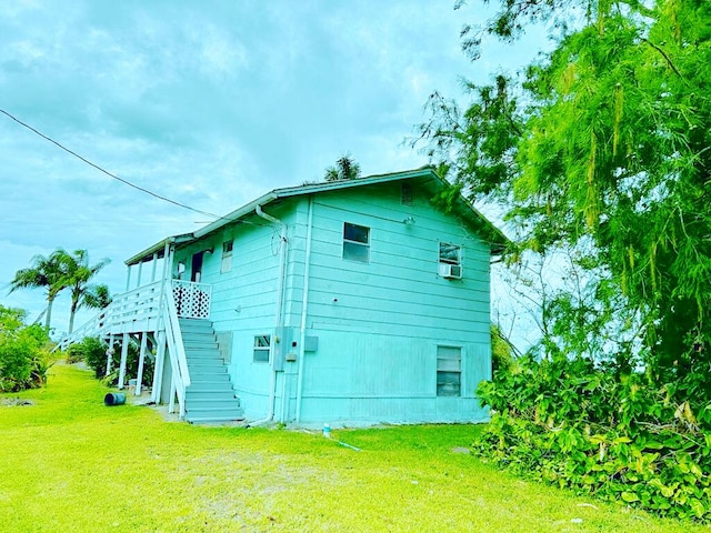 851 Riverside Dr, Moore Haven, FL 33471 - view of home's exterior with a lawn and stairway