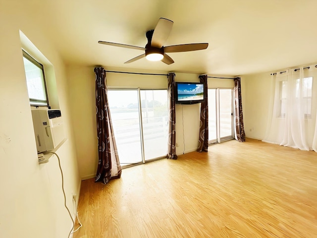 851 Riverside Dr, Moore Haven, FL 33471 - spare room featuring healthy amount of natural light, a ceiling fan, wood finished floors, and baseboards