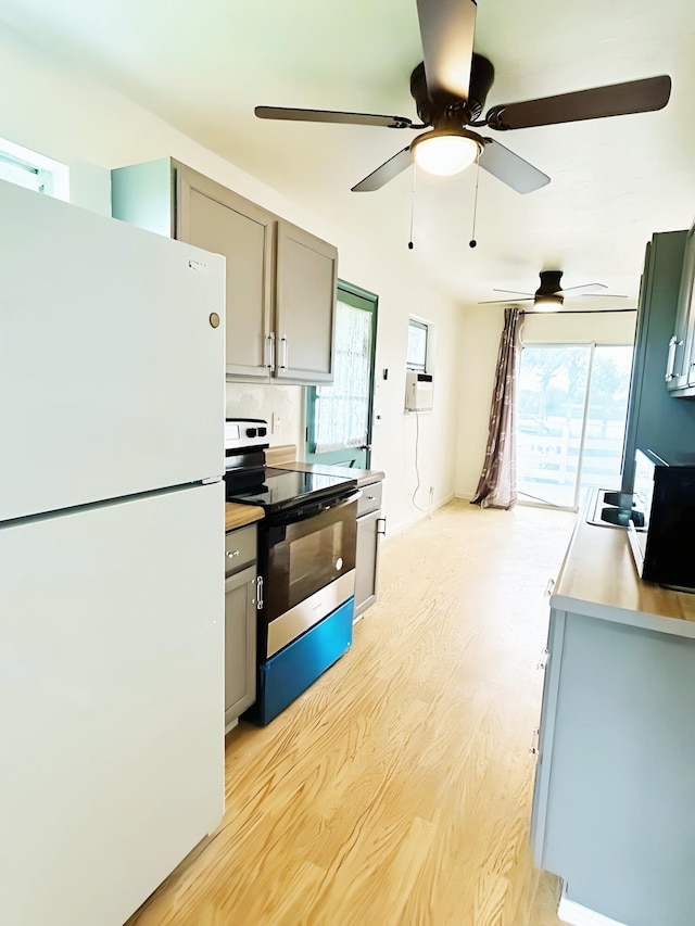 851 Riverside Dr, Moore Haven, FL 33471 - kitchen featuring freestanding refrigerator, electric range oven, gray cabinets, and light wood-style floors