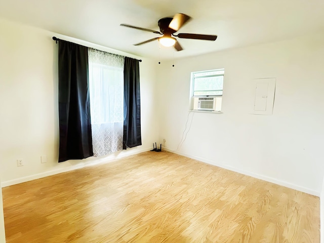 851 Riverside Dr, Moore Haven, FL 33471 - spare room featuring wood finished floors, ceiling fan, electric panel, baseboards, and cooling unit