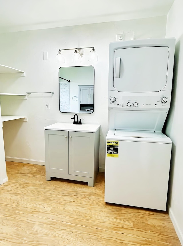851 Riverside Dr, Moore Haven, FL 33471 - washroom with stacked washing machine and dryer, baseboards, and light wood-type flooring