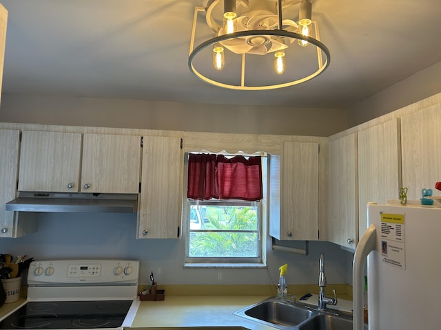 kitchen featuring white appliances, under cabinet range hood, a sink, a chandelier, and light countertops