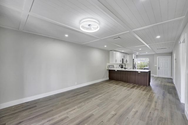 5048 Petal Pl Unit C, Delray Beach, FL 33484 - unfurnished living room with light wood-style floors, baseboards, recessed lighting, and a sink