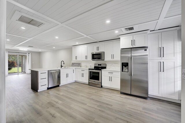 5048 Petal Pl Unit C, Delray Beach, FL 33484 - kitchen with appliances with stainless steel finishes, a peninsula, light wood finished floors, light countertops, and recessed lighting