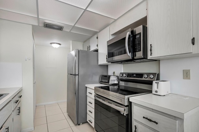 kitchen featuring appliances with stainless steel finishes, light countertops, and light tile patterned floors